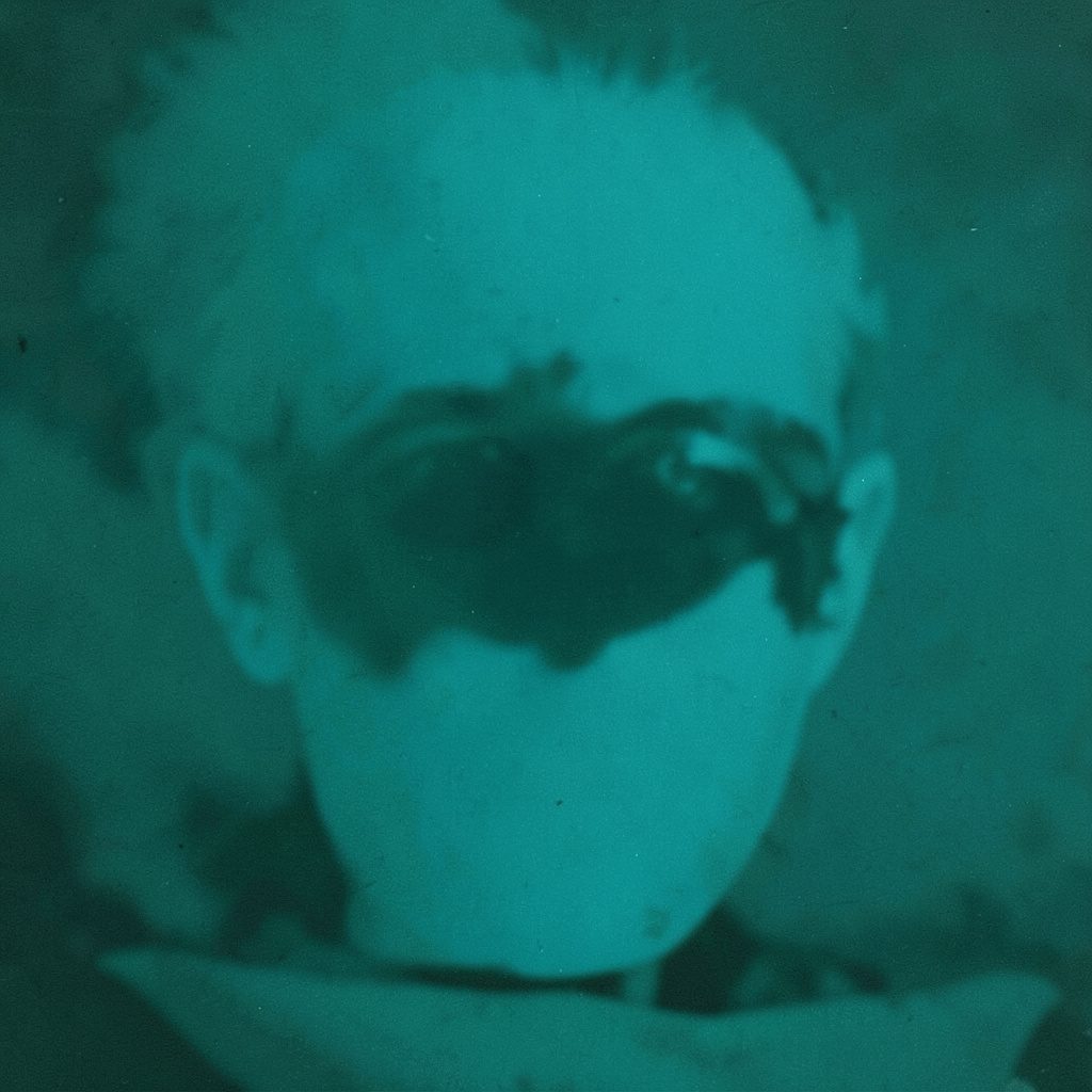 Two-tone image in charcoal and muted cream showing layered frames and broken silhouettes, evoking a corrupted video still